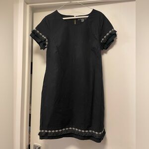 Black dress, above the knee length, pockets and fringe details